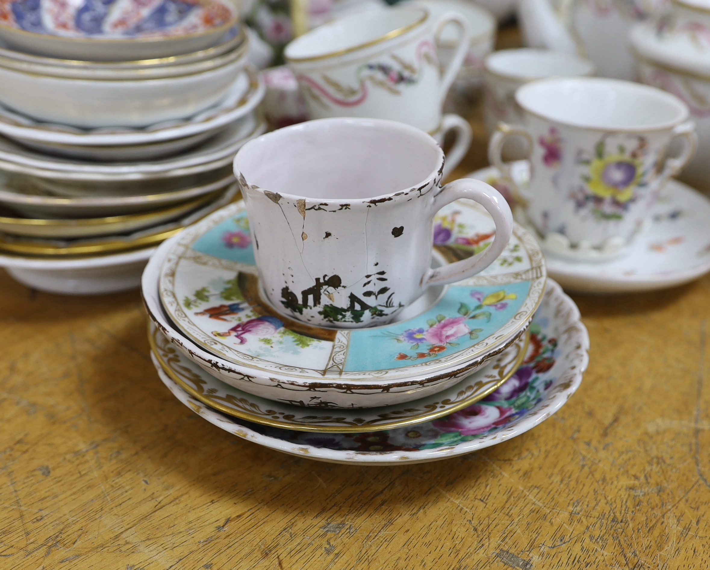 Assorted Continental ceramics, mainly 19th century, including two figures of parrots, two candle holders in the form of musicians, a teapot, jugs, various cups and sauces, etc.